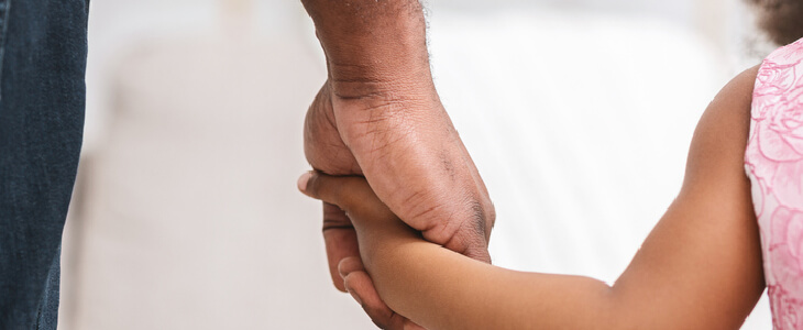 father holding his daughter's hand