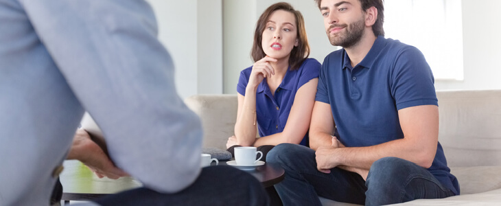 Divorcing couple consulting with a lawyer