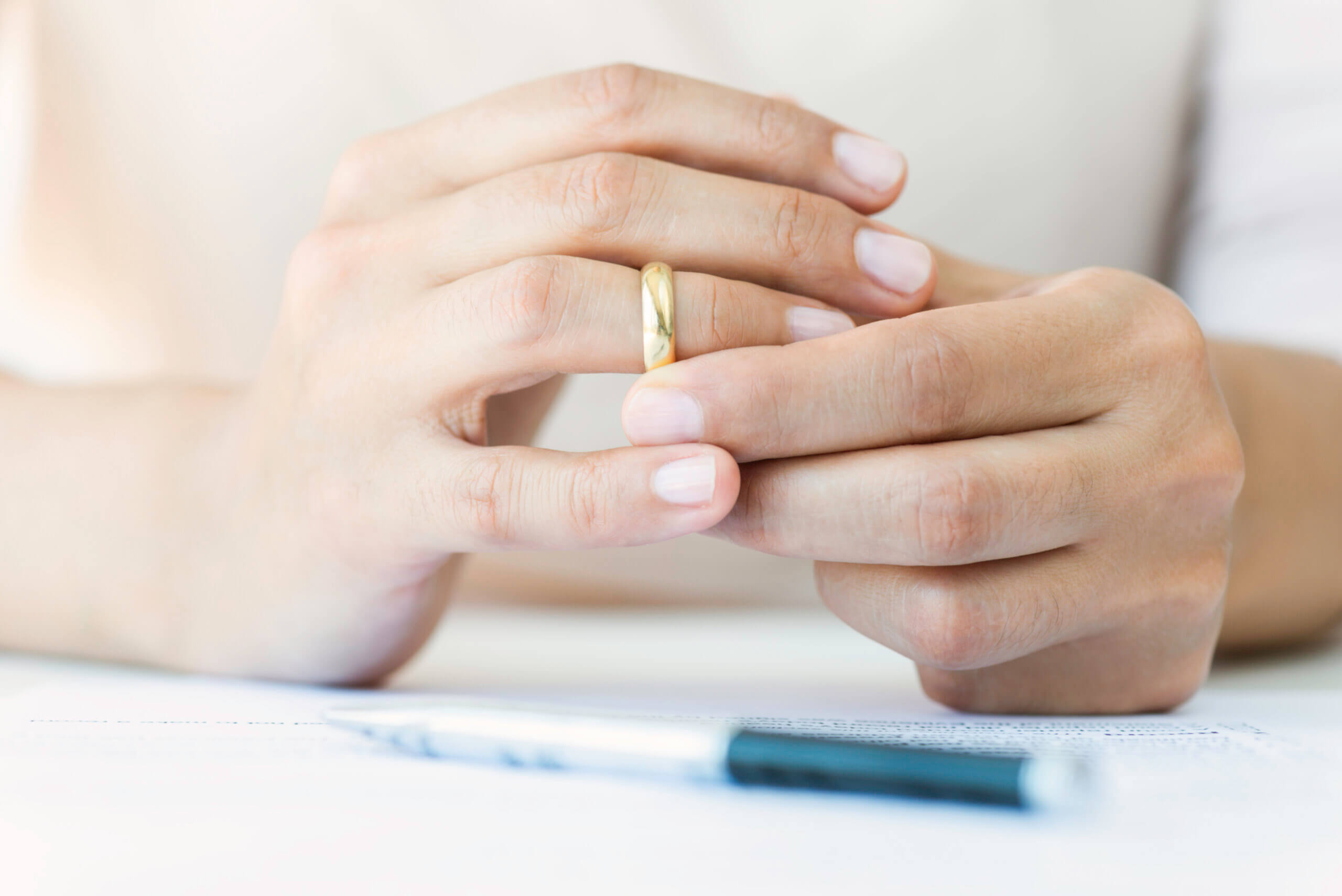 woman taking off her wedding ring