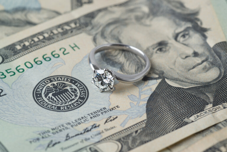 engagement ring on top of money