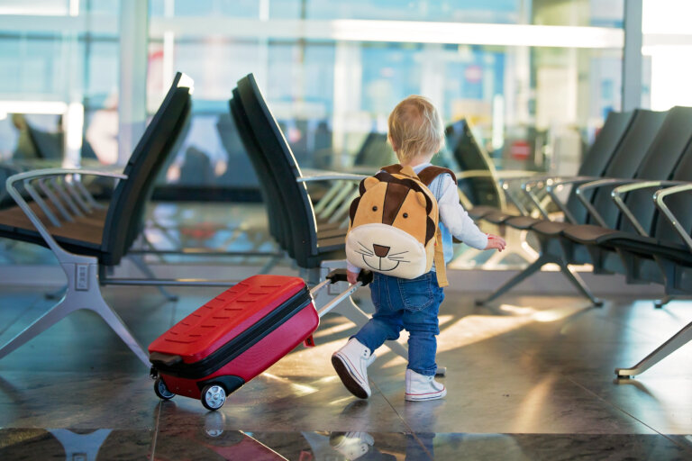 kid with luggage in airport