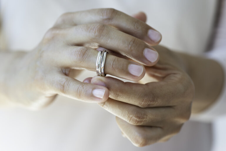 woman taking off her wedding ring