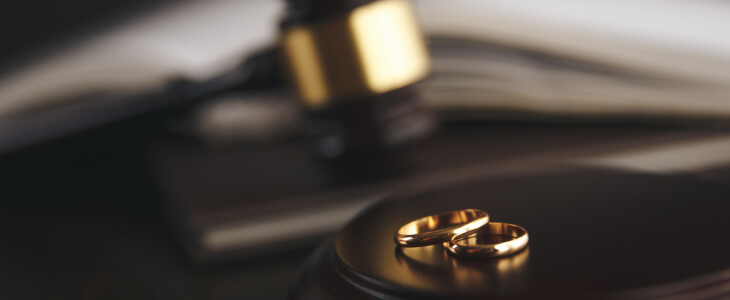 Two wedding rings with a gavel