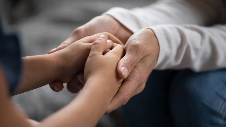 A mother holding her daughter's hands