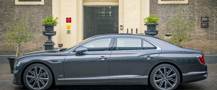 Bentley Flying Spur parked on the side of the road.