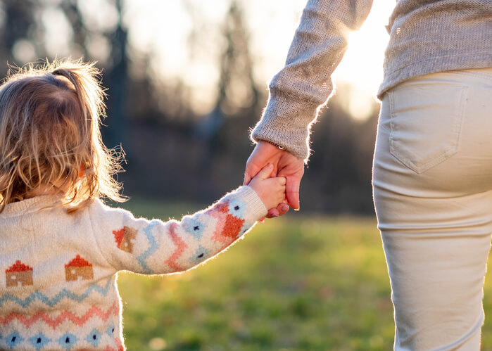 Mother holding her daughter's hands