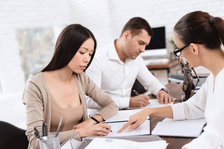 woman looking documents with divorce attorney