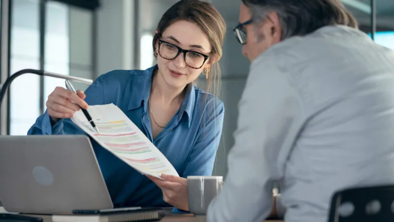 woman reviewing financial statement with older man